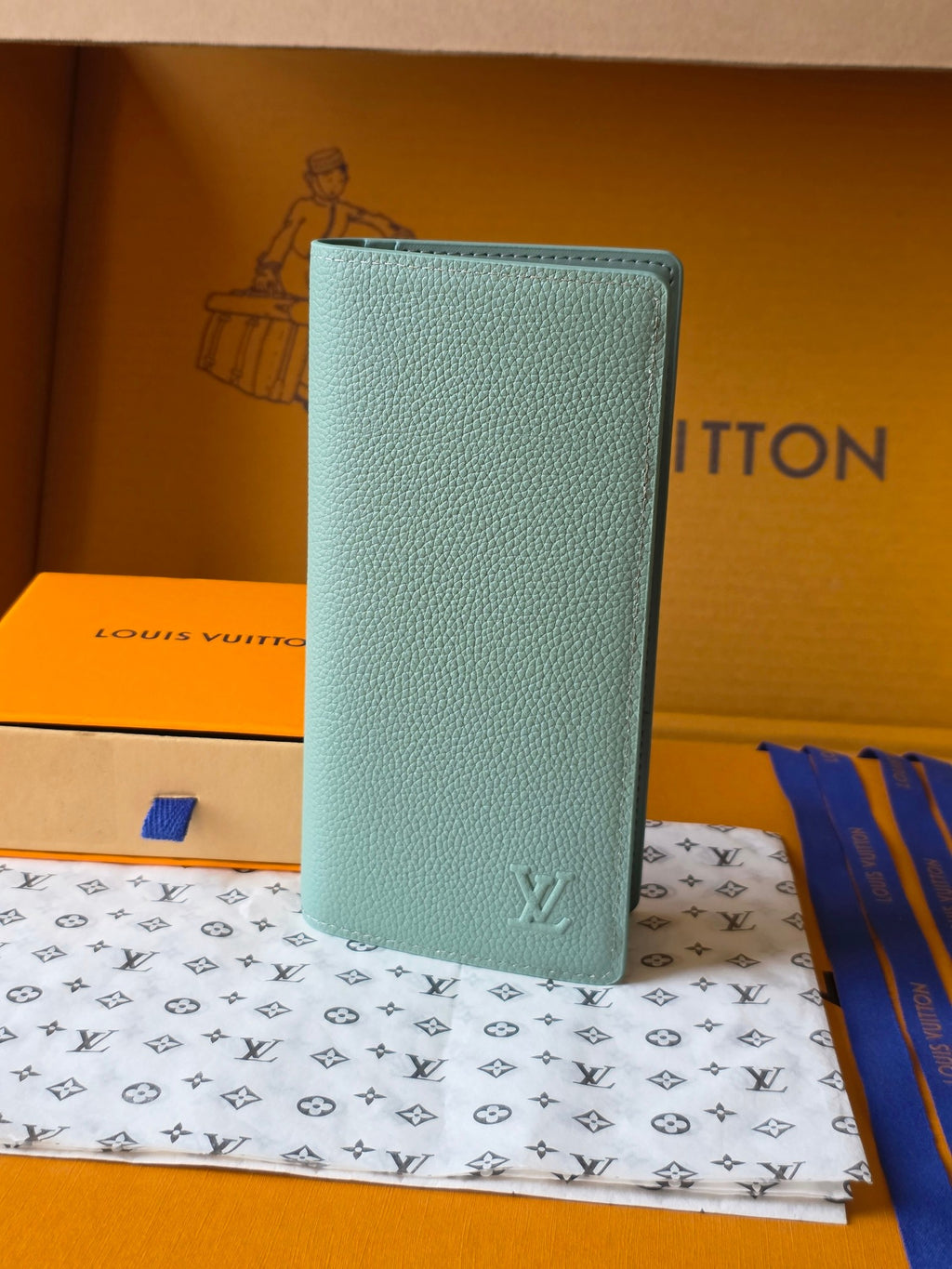 Light blue leather small bag with Louis Vuitton monogram on front panel