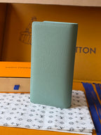 Light blue leather small bag upright view with Louis Vuitton logo on front