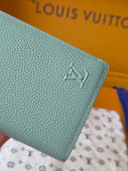 Light blue leather small bag with Louis Vuitton embossed emblem on front