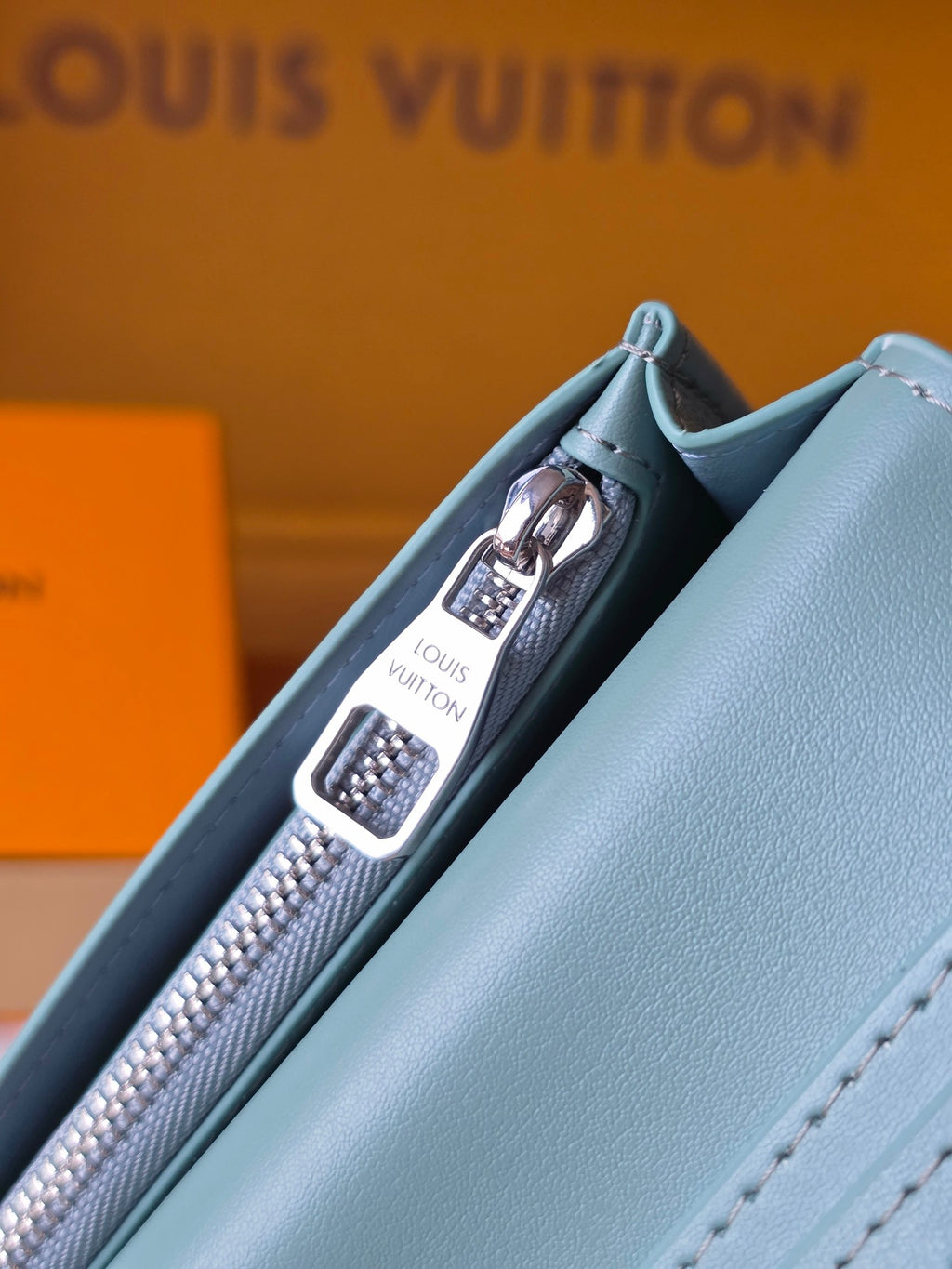 Light blue leather small bag interior with zipper pocket and Louis Vuitton branding