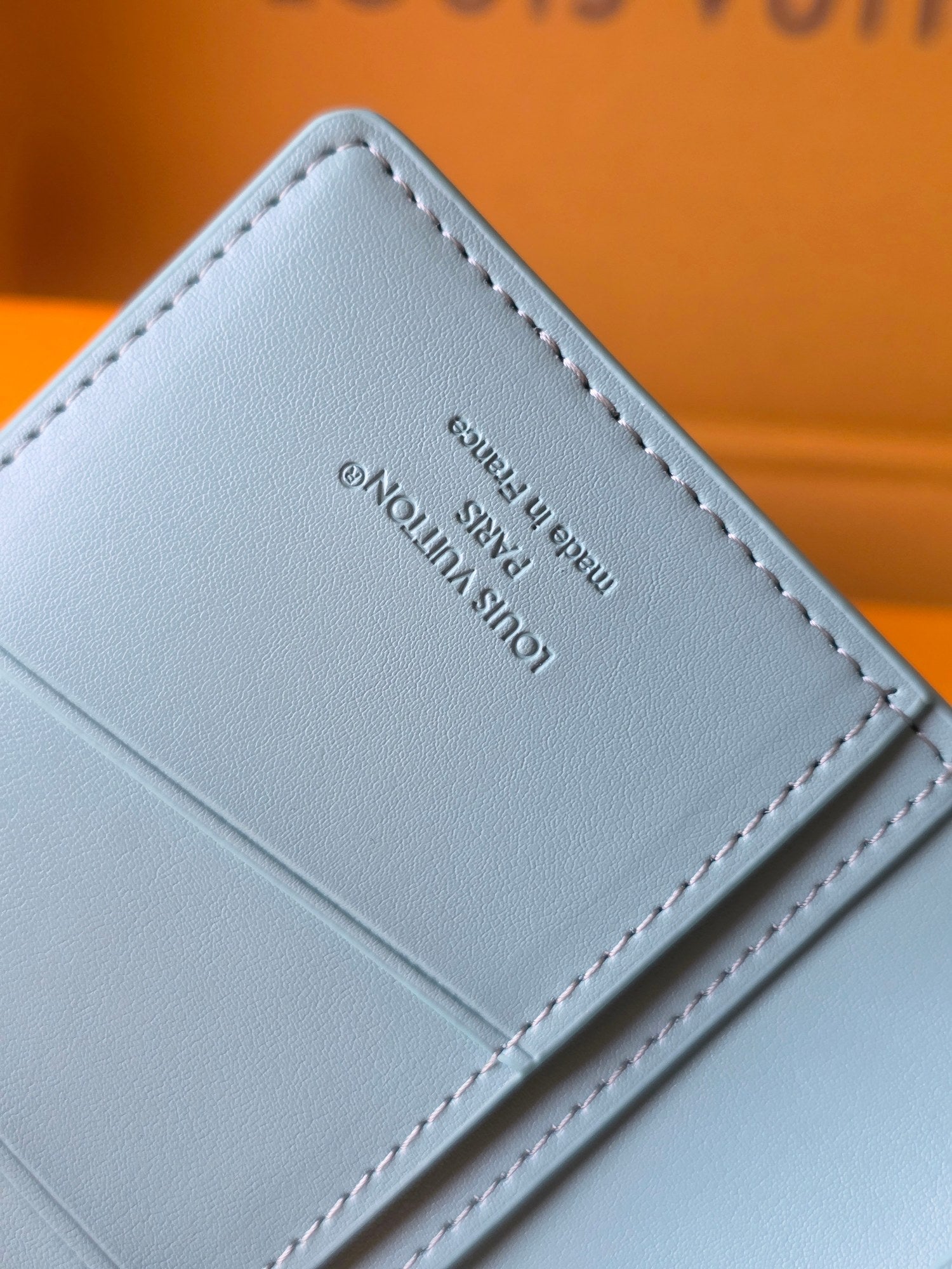 Light blue leather small bag interior with Louis Vuitton label and stitched edge