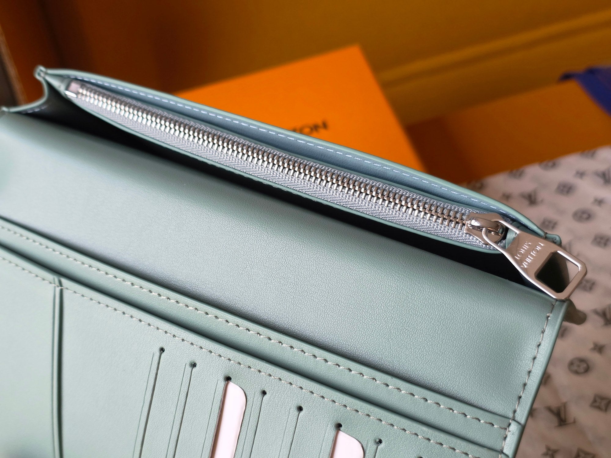 Light blue leather small bag with zipper compartment and silver metal hardware