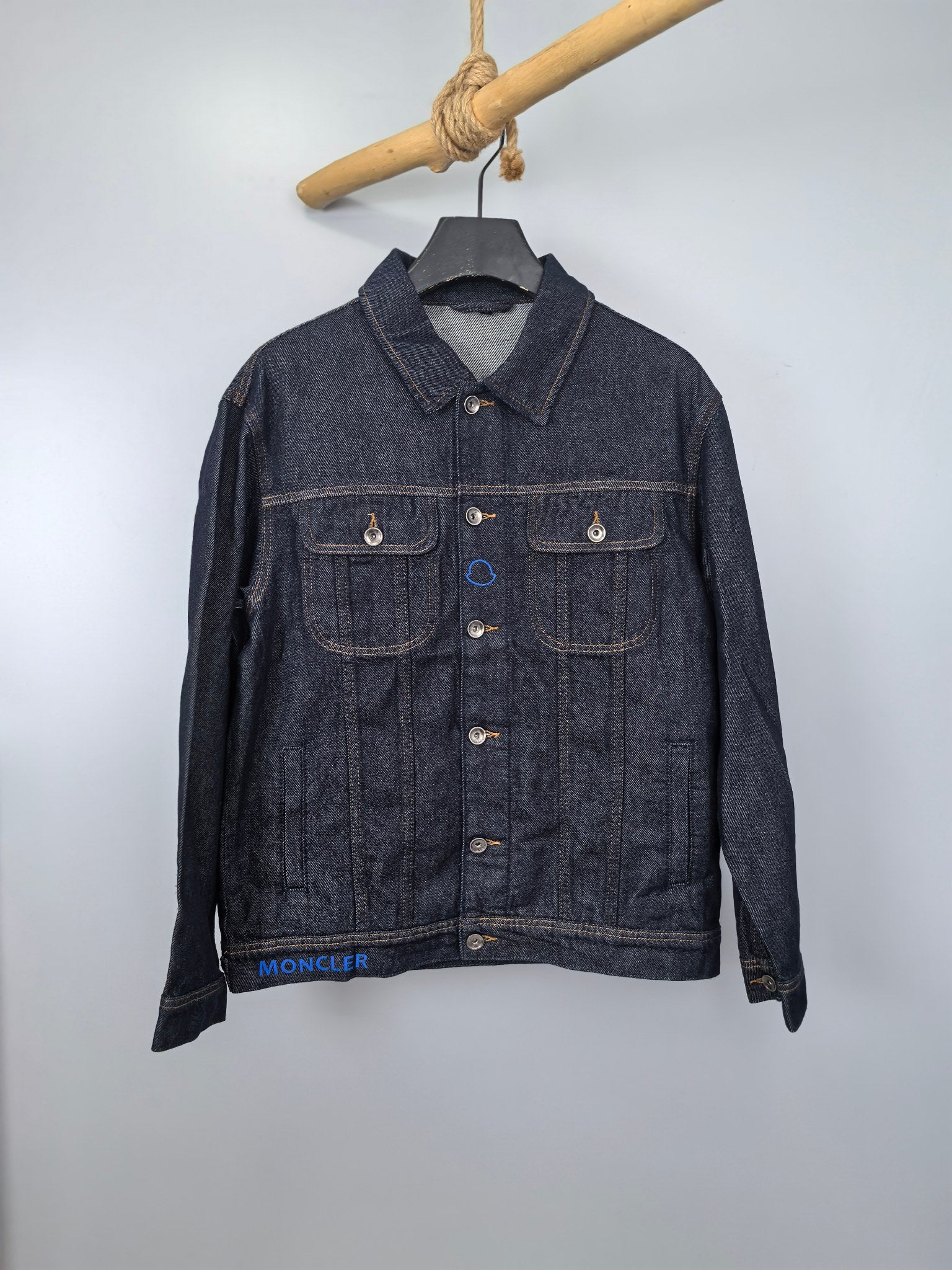 Moncler dark denim jacket with button front, pointed collar, and chest flap pockets