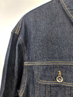 Moncler dark denim jacket close-up of shoulder seam and chest flap pocket