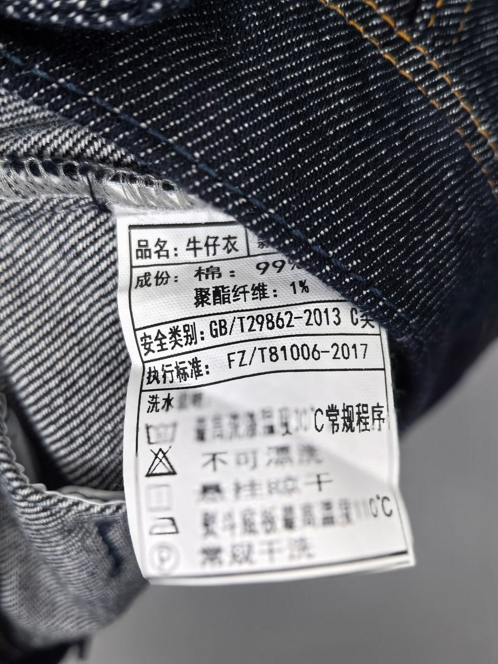 Moncler denim jacket interior care label with printed fabric and washing information