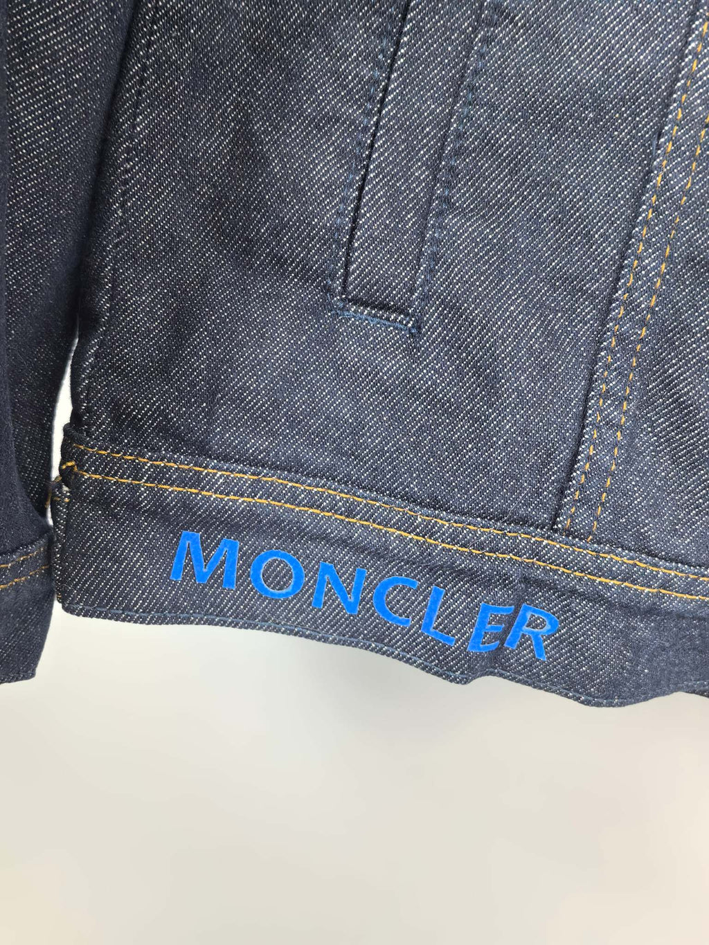 Moncler dark denim jacket hem with Moncler logo print on the cuff area