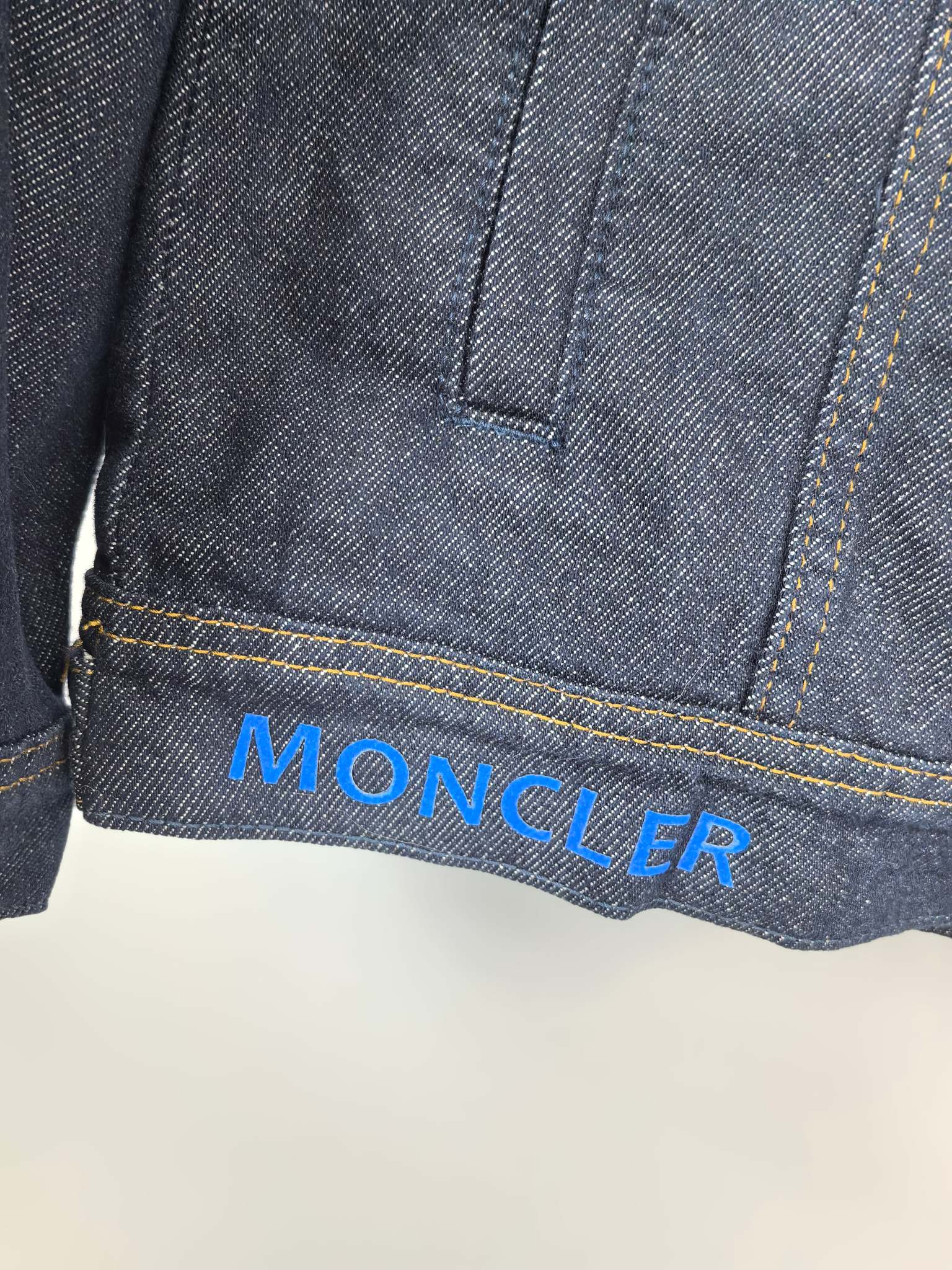Moncler dark denim jacket hem with Moncler logo print on the cuff area