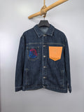 Blue denim jacket with button front, point collar, and chest graphic patch