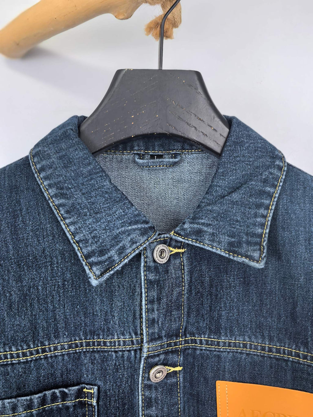 Blue denim jacket close-up of point collar and button front