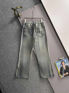 Denim pants on hanger, light wash with Gucci logo patch, belt loops, button-fly