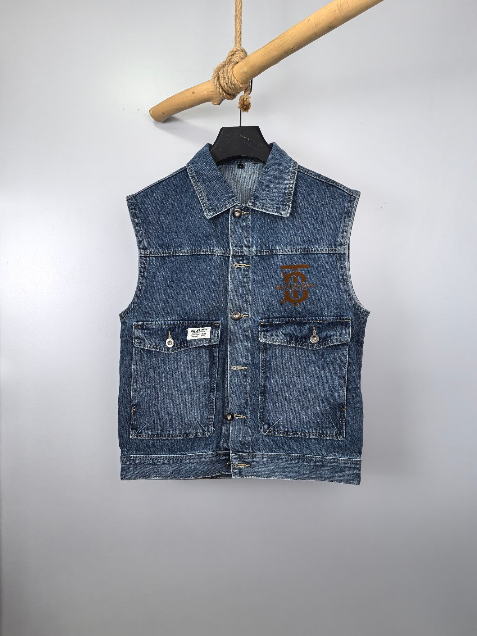 Burberry blue denim vest with front patch pockets and metal button closure