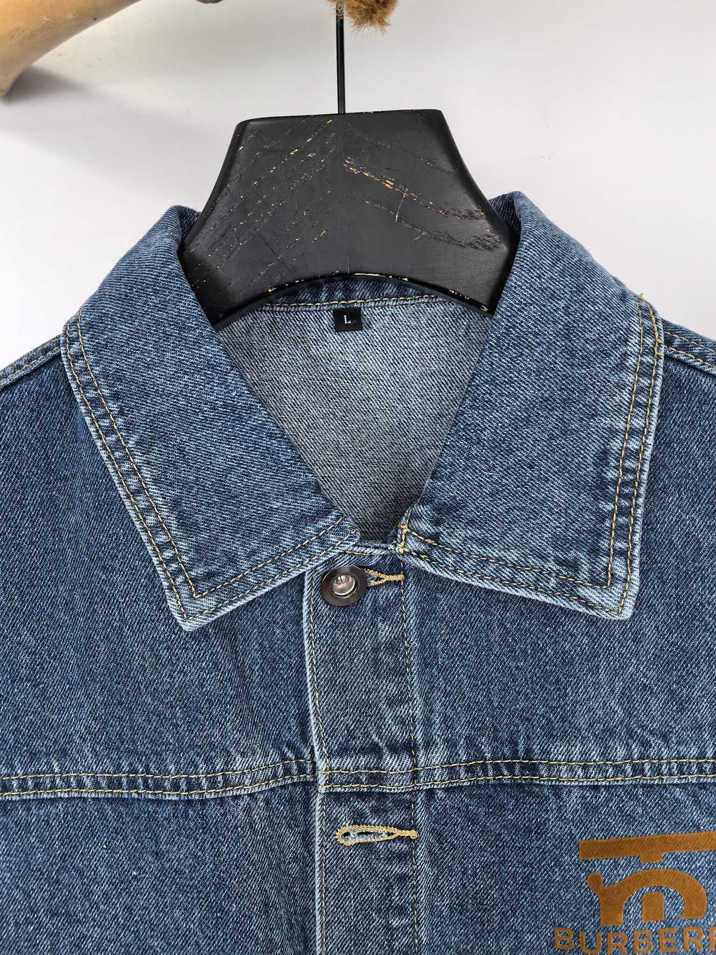 Burberry denim vest close-up of pointed collar and button placket
