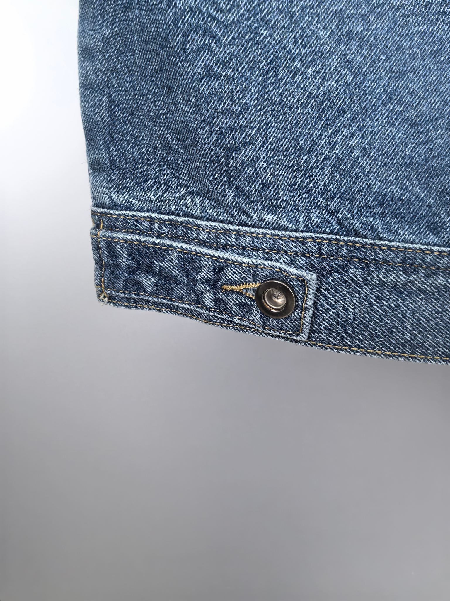 Burberry denim vest cuff detail with metal button and folded hem stitch