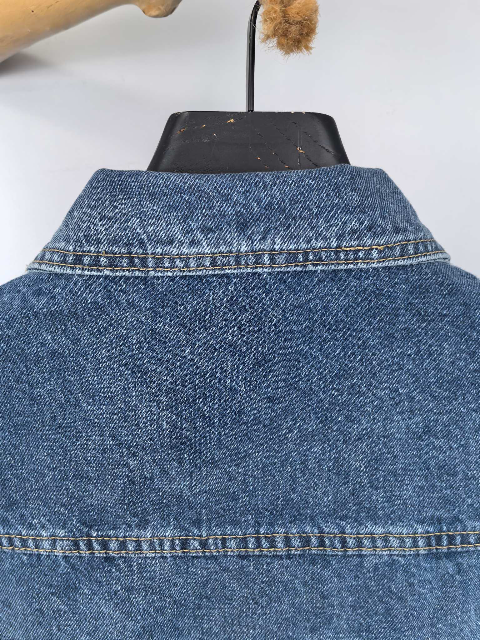 Burberry blue denim vest back view showing yoke seam and collar stitching
