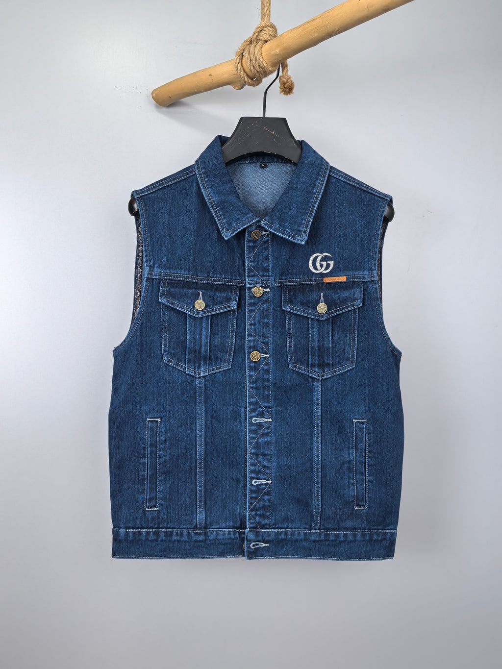 Gucci blue denim sleeveless vest with button pockets and GG logo on the chest