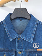 Gucci blue denim sleeveless vest with pointed collar and GG logo patch at chest
