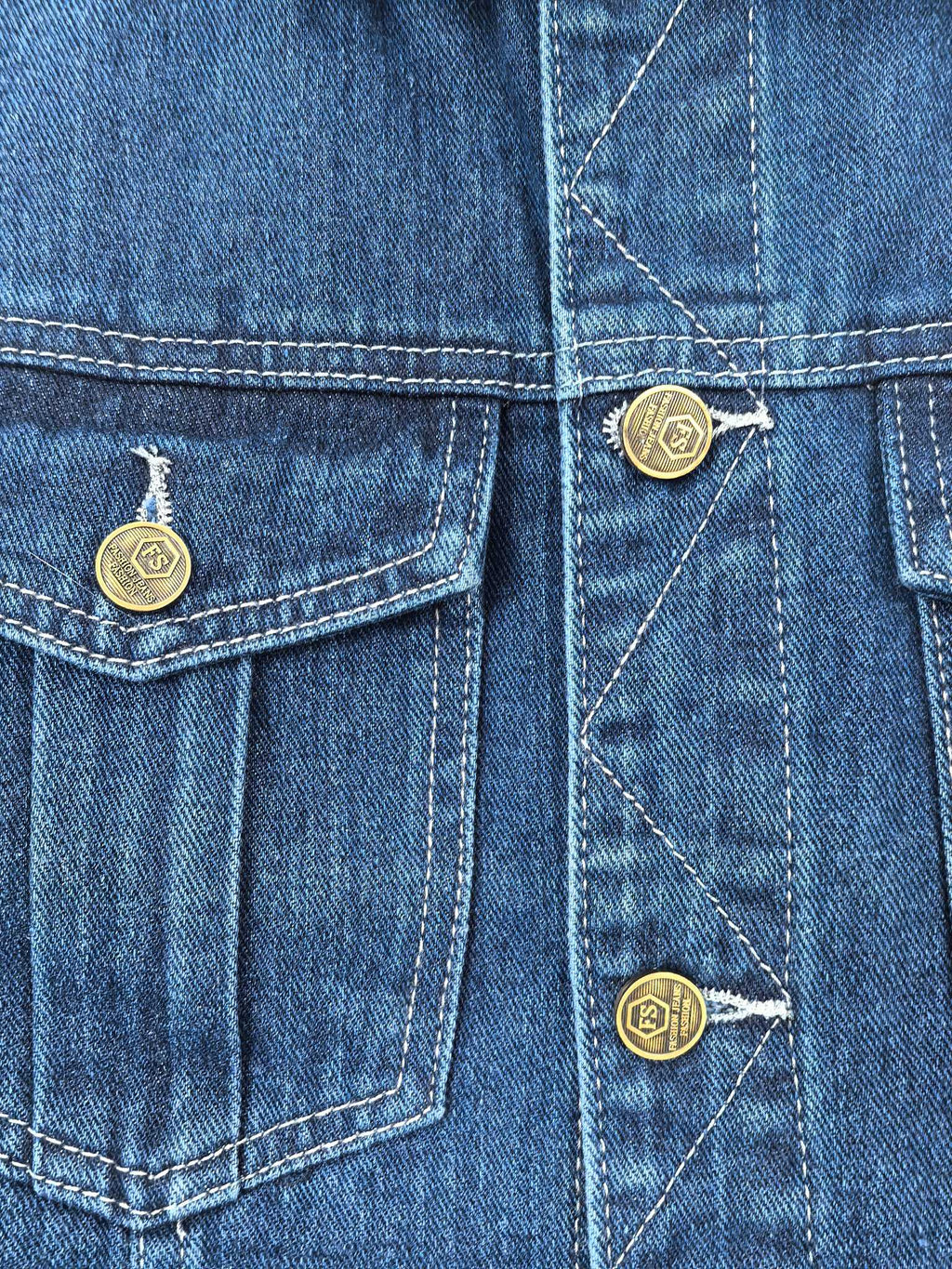 Gucci blue denim vest close-up of front pockets with button details and stitching