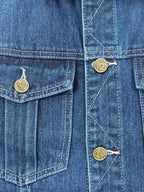 Gucci blue denim vest close-up of front pockets with button details and stitching
