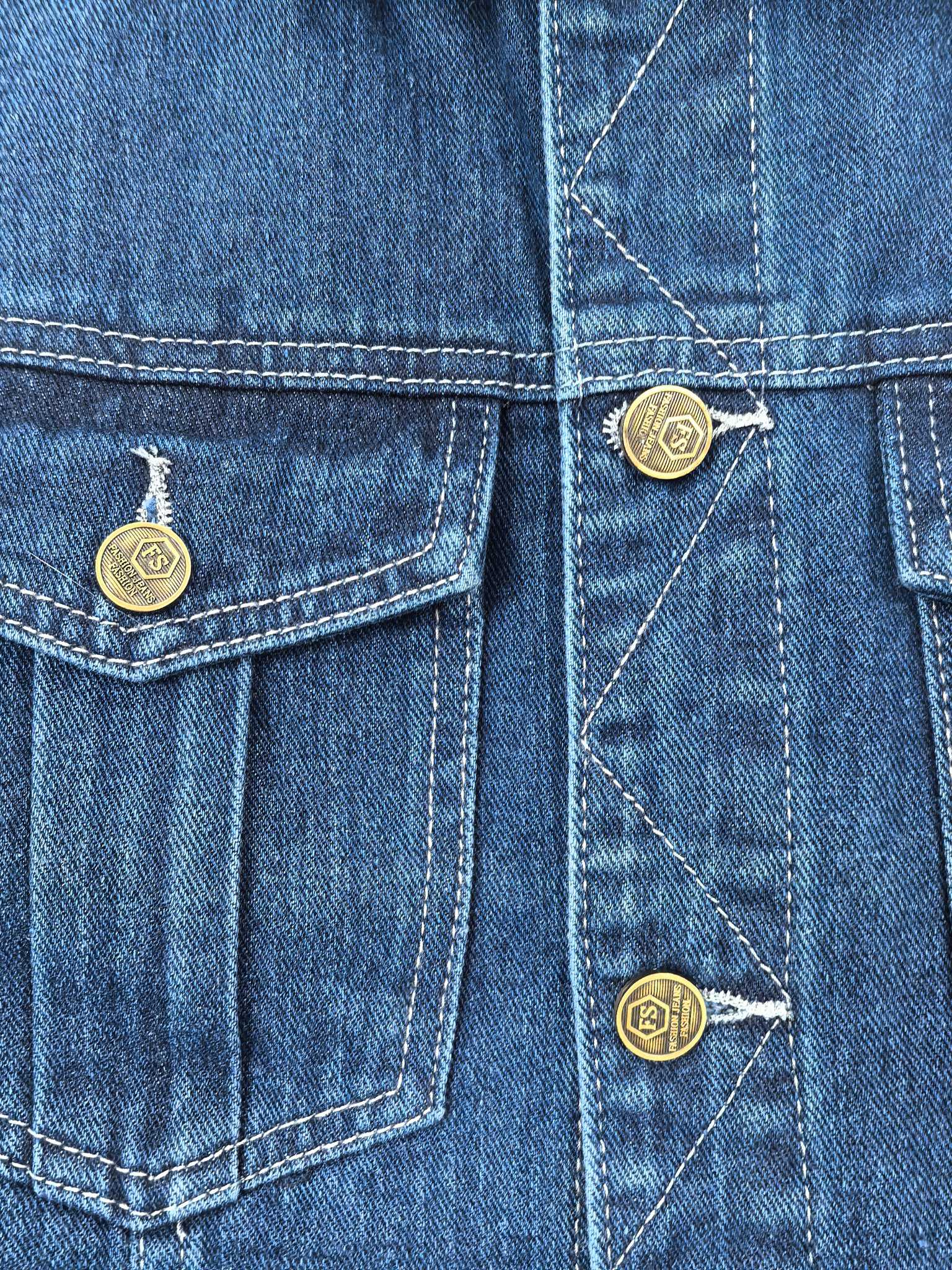 Gucci blue denim vest close-up of front pockets with button details and stitching