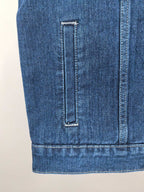 Gucci blue denim vest back lower section with vertical seam and pocket edge