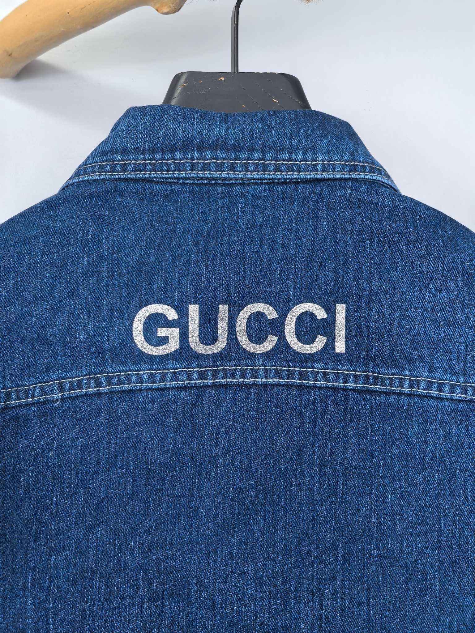 Gucci blue denim vest back collar with large GUCCI lettering