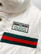 Gucci logo patch on white puffer jacket with green and red stripe band