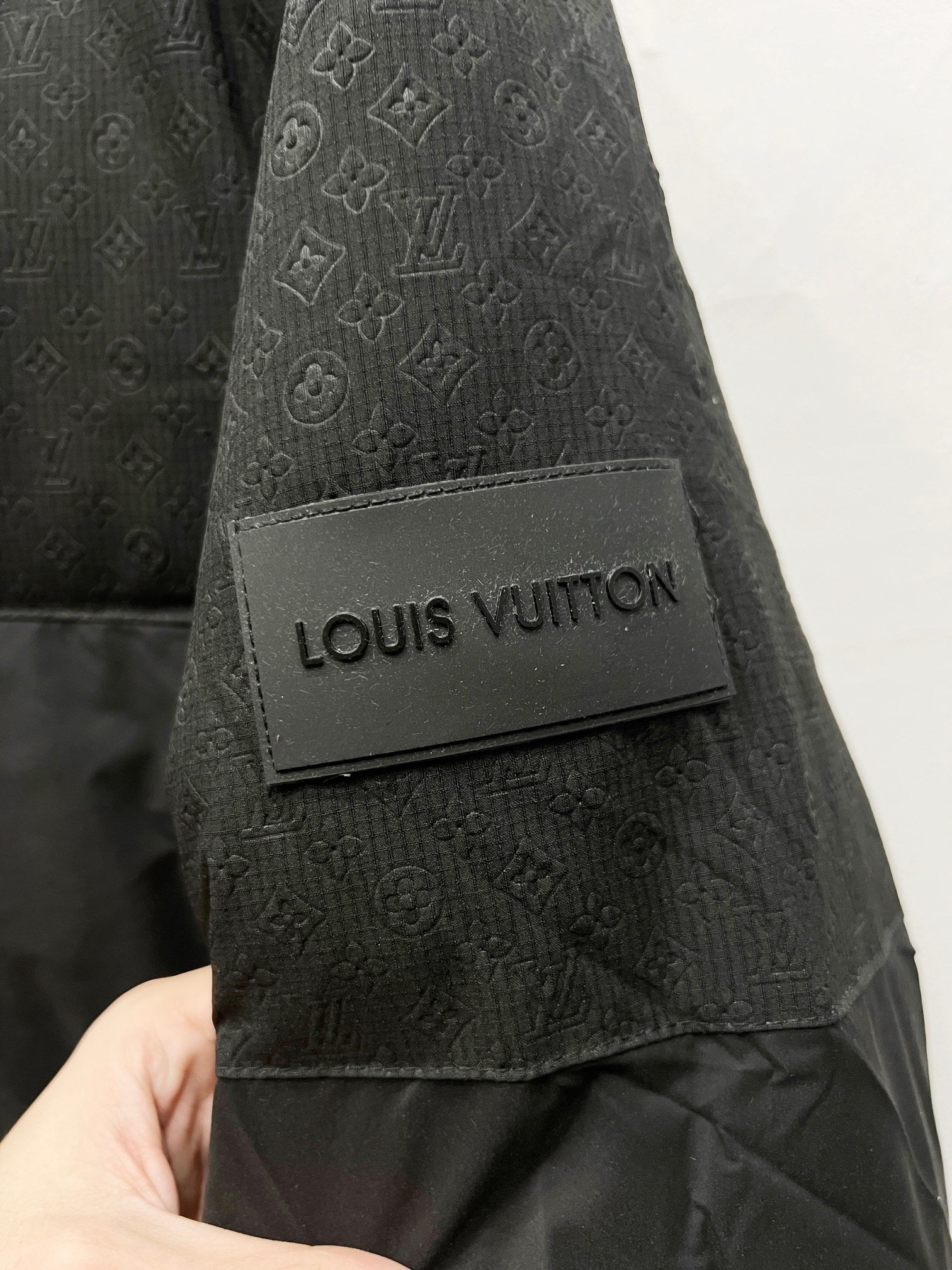 Louis Vuitton logo patch on dark gray fabric cuff
