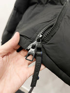Puffer jacket zipper pull with Louis Vuitton keyring tag
