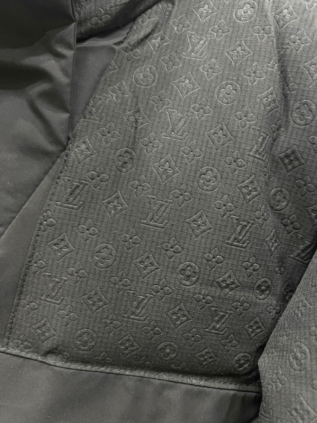 Dark gray monogram-pattern puffer jacket fabric panel