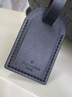 Louis Vuitton leather luggage tag, dark navy with stitched edge and logo