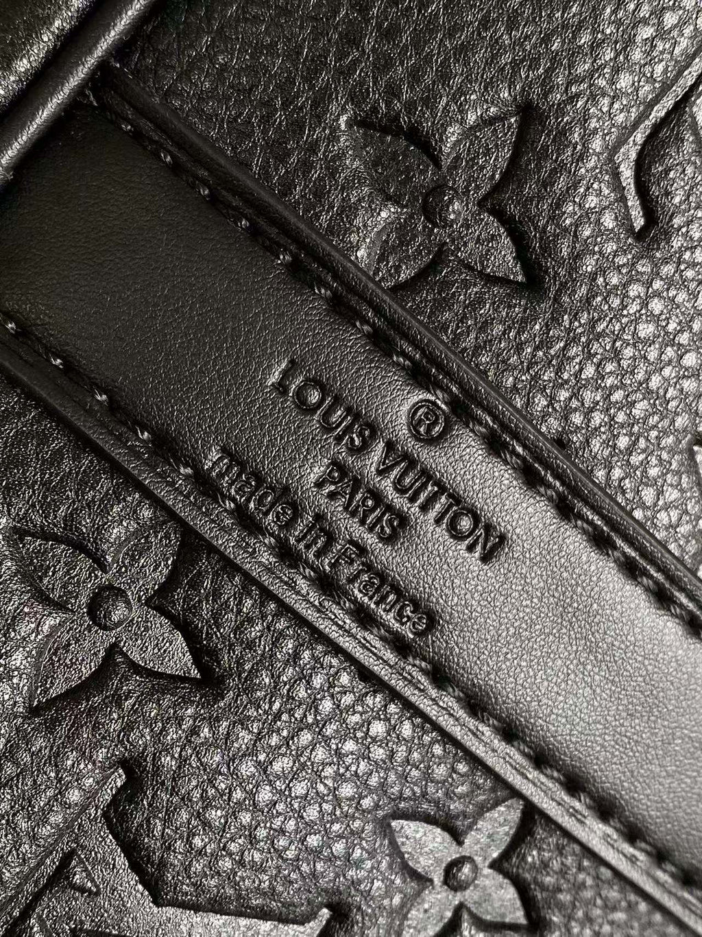 Louis Vuitton monogram leather with embossed flowers and stitched edge, dark navy