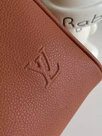 Brown textured leather with embossed Louis Vuitton-style logo detail