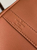 Brown leather handbag with stitched inner pocket label strip