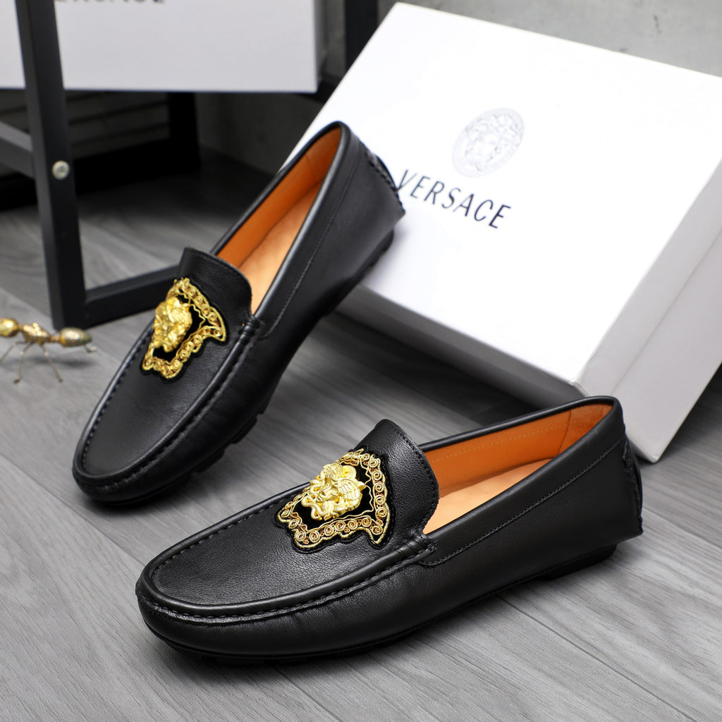 Versace black leather loafers with gold emblem and orange interior lining