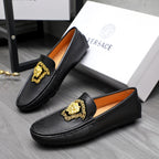 Versace black leather loafers with gold emblem and orange interior lining