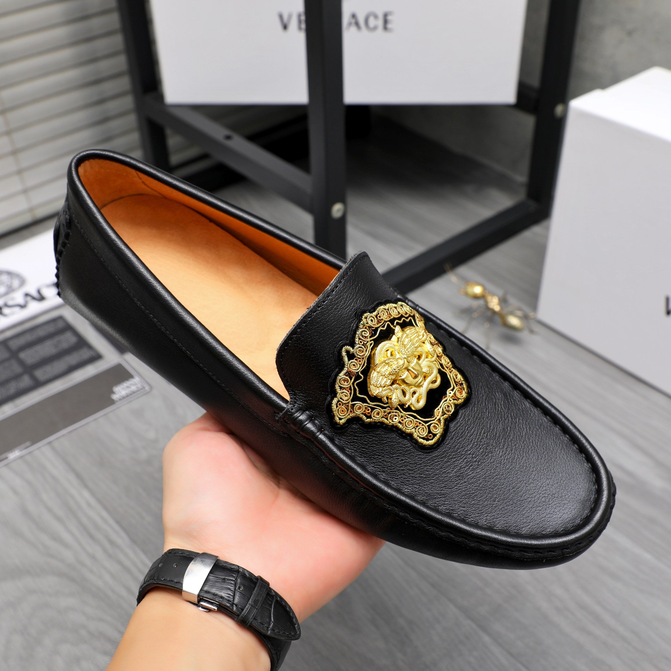 Versace black leather loafer with gold medallion front and orange lining