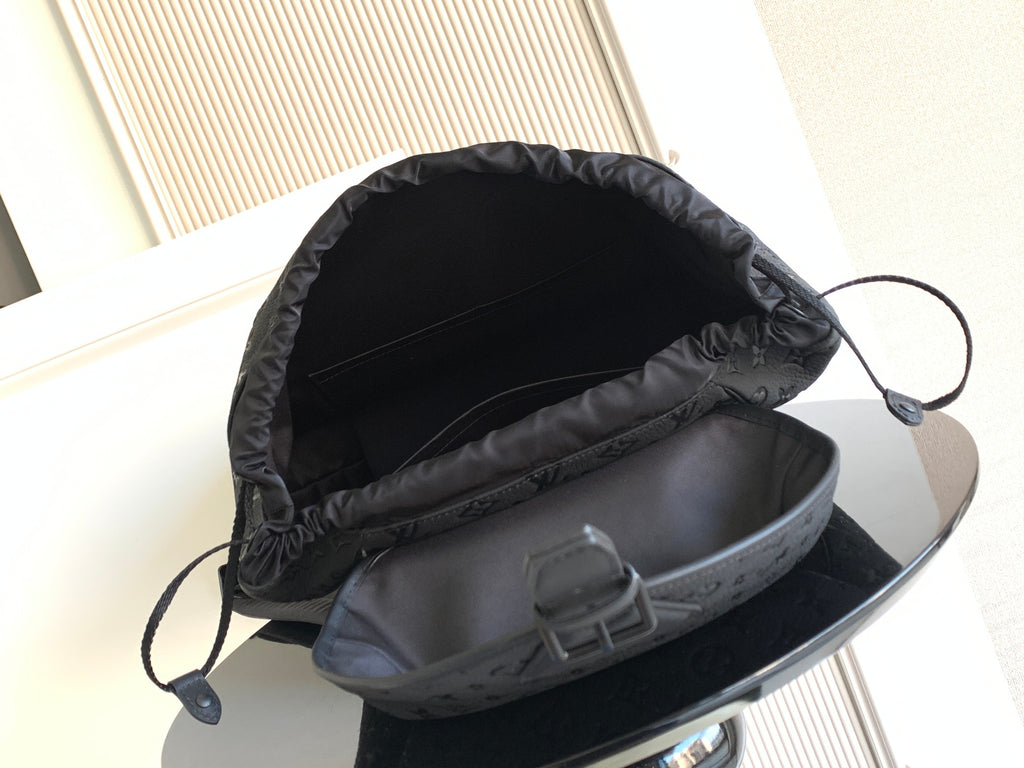 Louis Vuitton monogram backpack open top showing gray lining and drawstring cord
