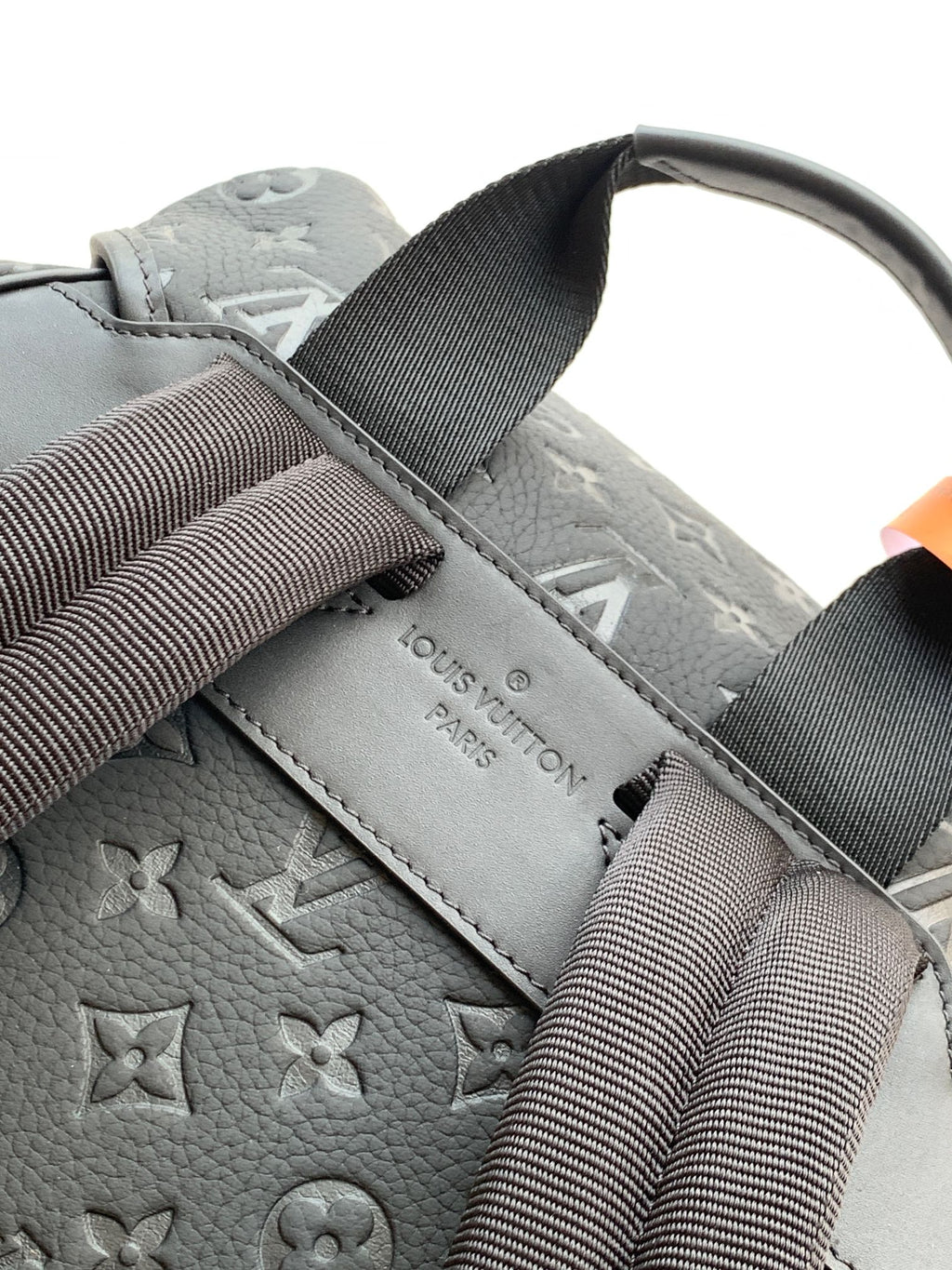 Louis Vuitton monogram backpack in light gray with webbing shoulder straps and embossed logo