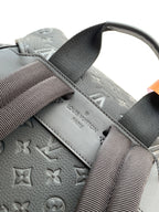 Louis Vuitton monogram backpack in light gray with webbing shoulder straps and embossed logo