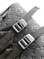Louis Vuitton monogram backpack in light gray with silver-tone buckles and strap hardware