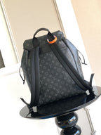 Monogram backpack with front pocket and adjustable shoulder straps; dark gray