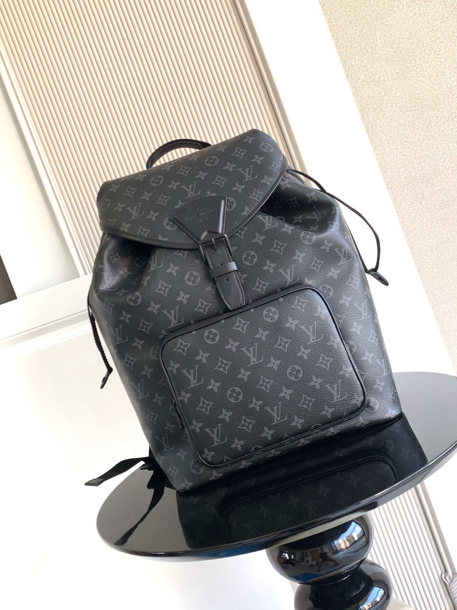 Louis Vuitton monogram backpack in dark gray with front flap and tie closure