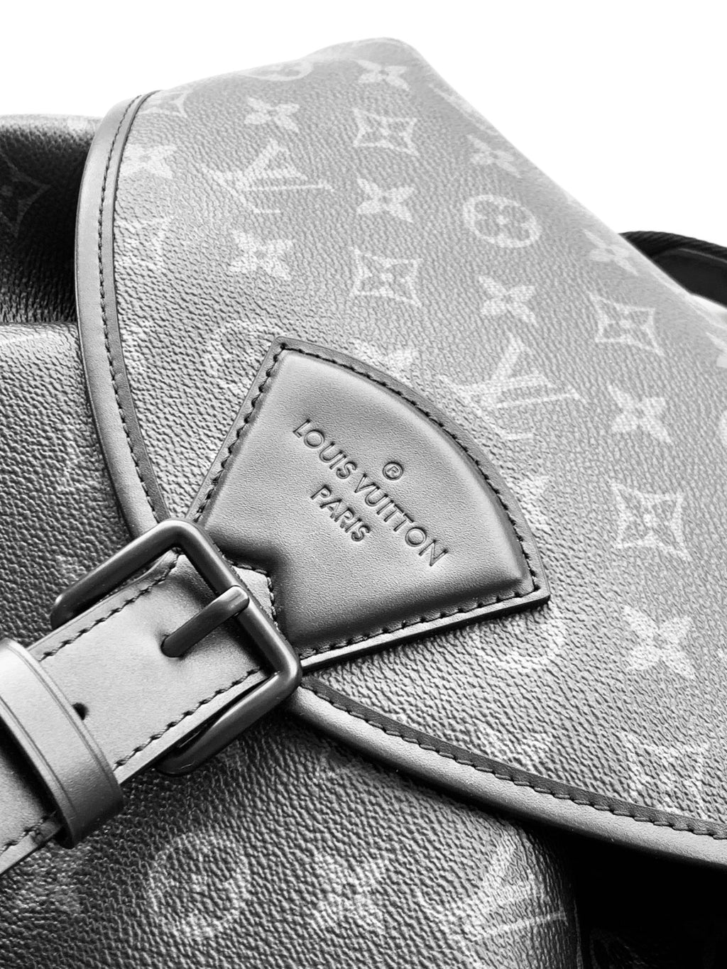 Louis Vuitton monogram backpack corner detail with gray leather panel and buckle