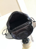 Monogram backpack interior with drawstring opening and black fabric lining