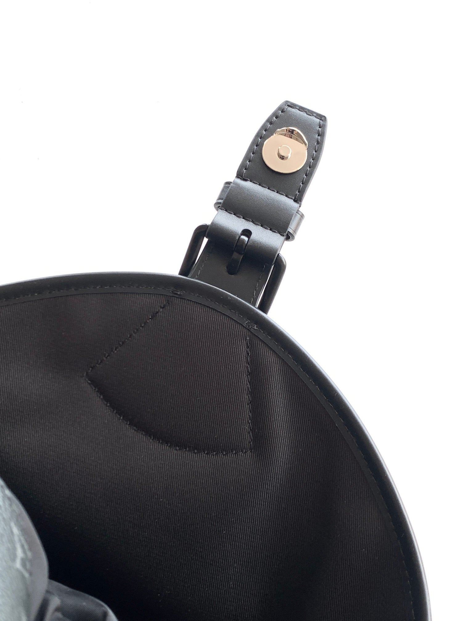 Black Louis Vuitton backpack strap connector with metal buckle on leather loop