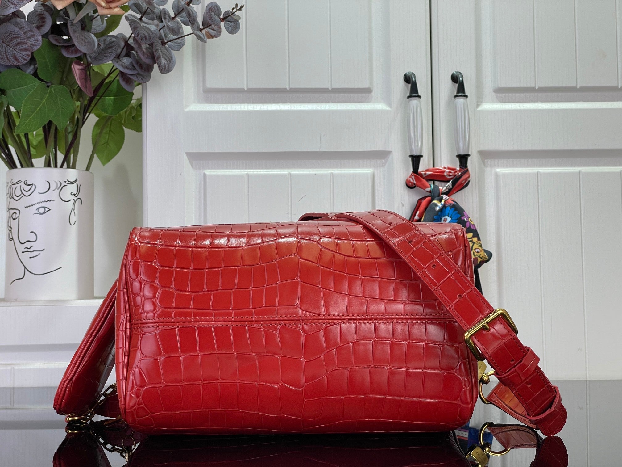Louis Vuitton red croc-embossed handbag with front strap detail and adjustable crossbody strap