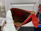 Louis Vuitton red bag open top with white lining, zip closure, and gold zipper pull