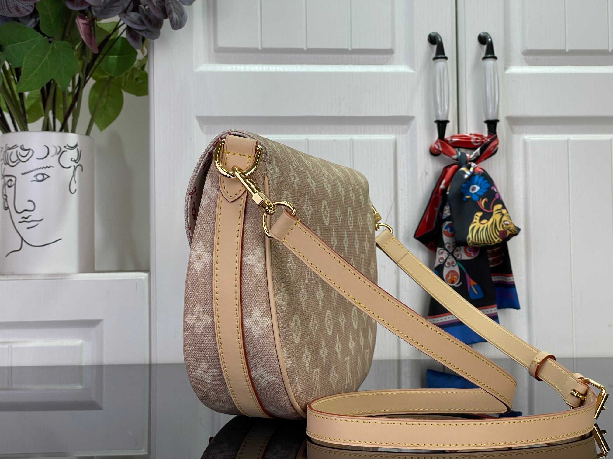 Louis Vuitton monogram crossbody bag with flap, tan leather strap and gold hardware