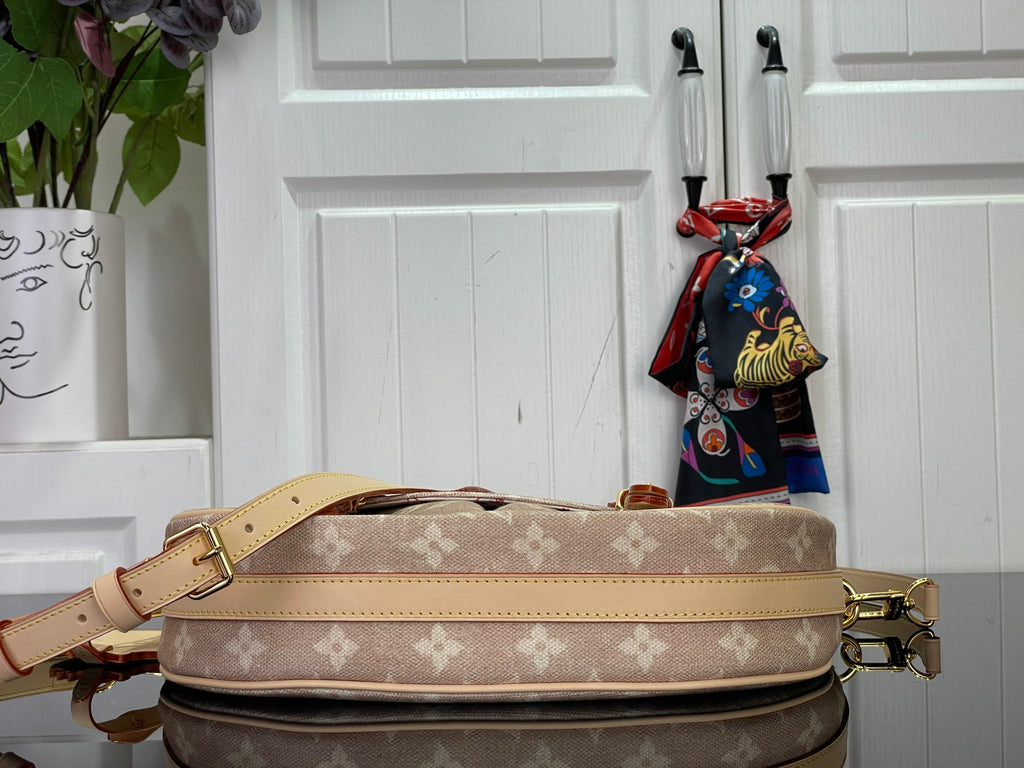 Louis Vuitton monogram shoulder bag with wide tan strap and gold hardware