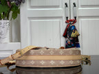 Louis Vuitton monogram shoulder bag with wide tan strap and gold hardware